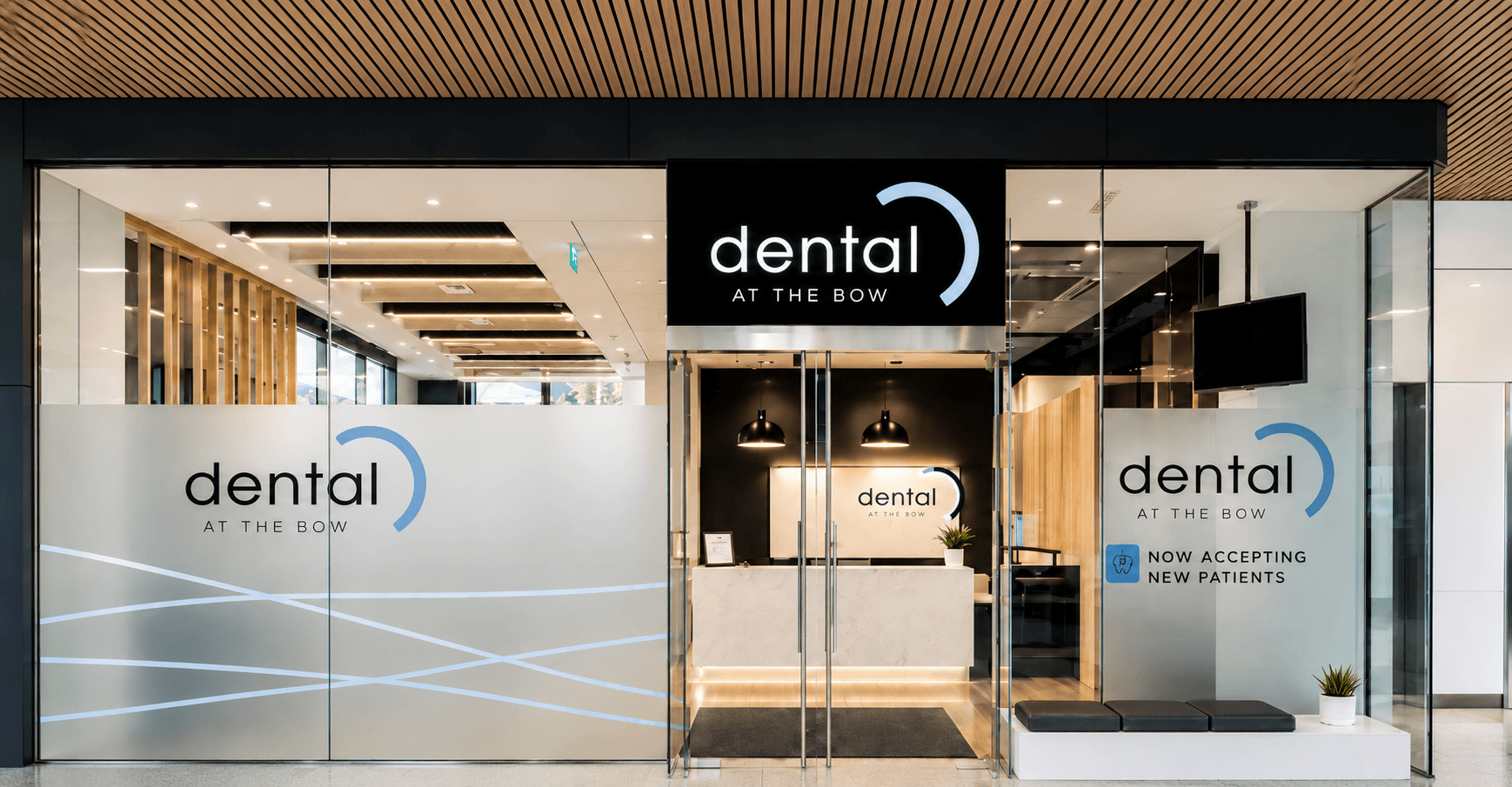 The glass clinic entrance beneath the Dental at the Bow sign